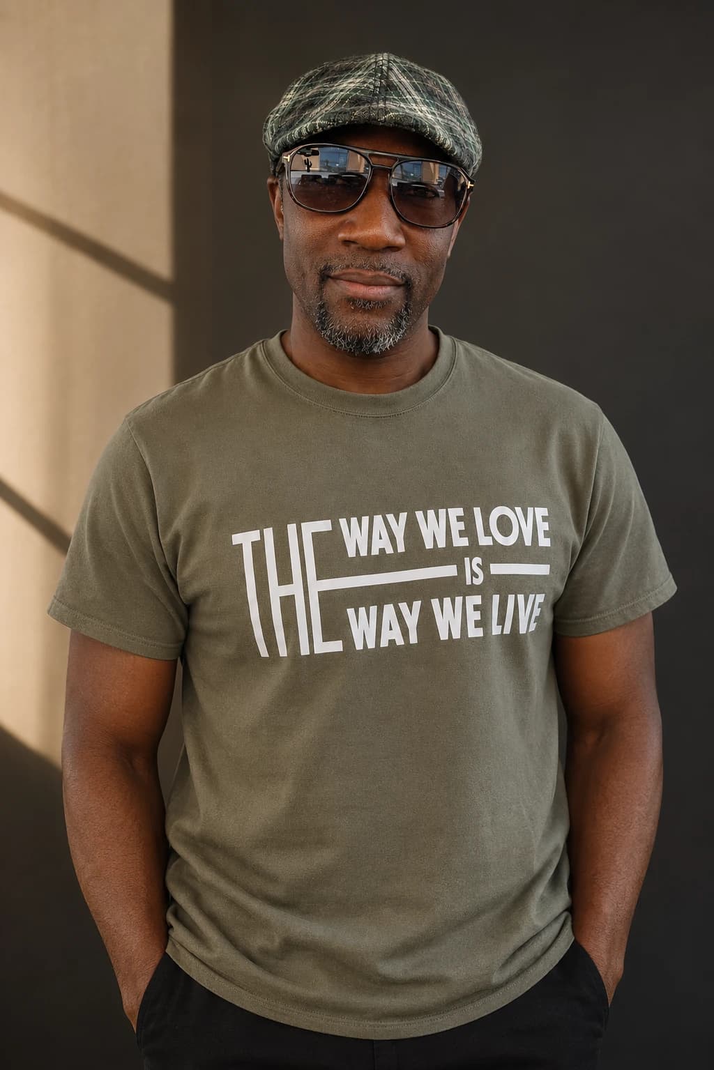 AI-assisted editorial image of Michael E. Martin Jr. wearing an olive The Way We Love Is the Way We Live shirt